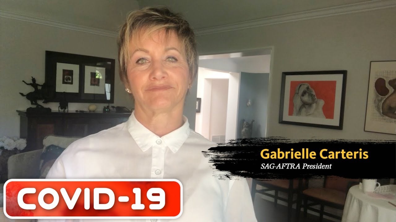 Carteris in white button up with living room in background