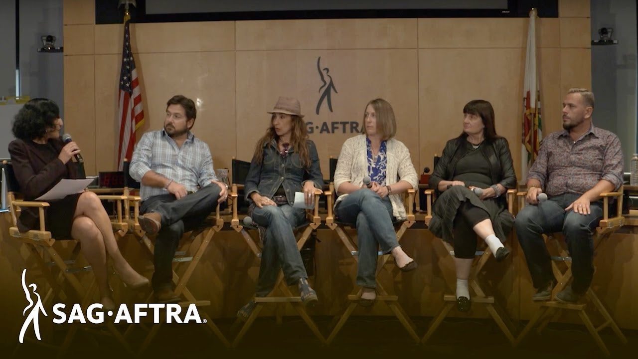 Row of panelists sitting in director chairs