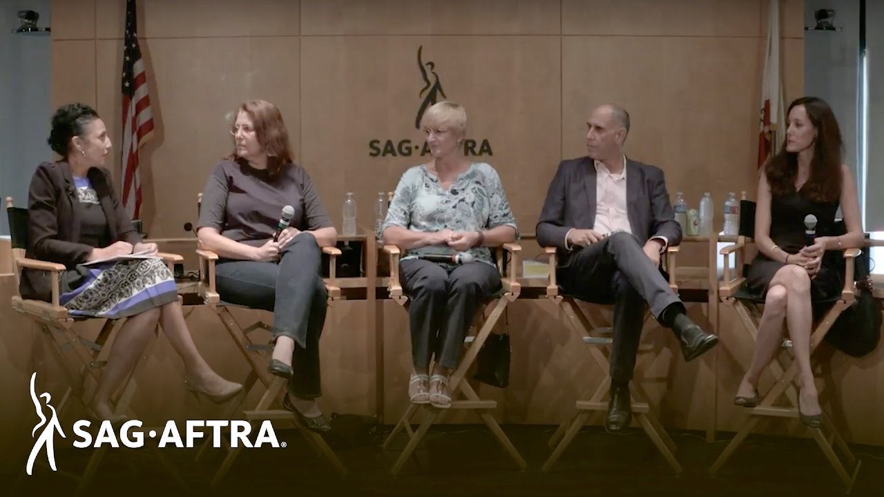 Row of panelists sitting in director chairs