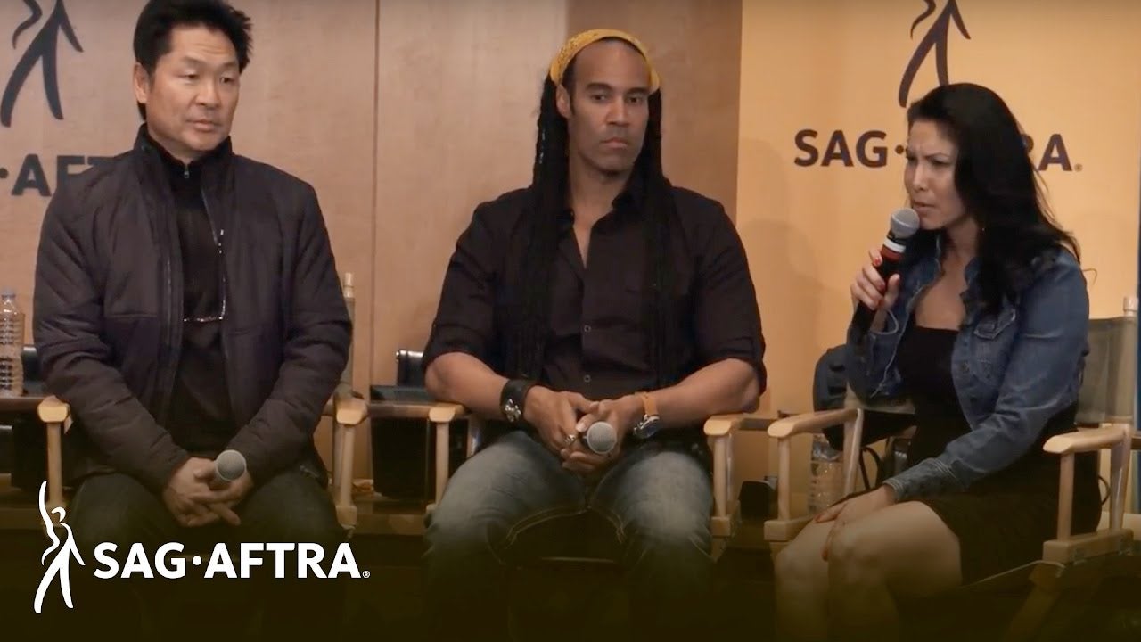 Panelist sitting on director chairs speaking to audience