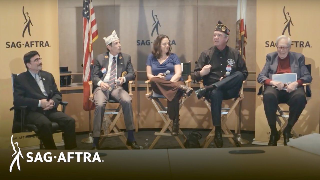 Row of veteran panelists dressed in uniforms