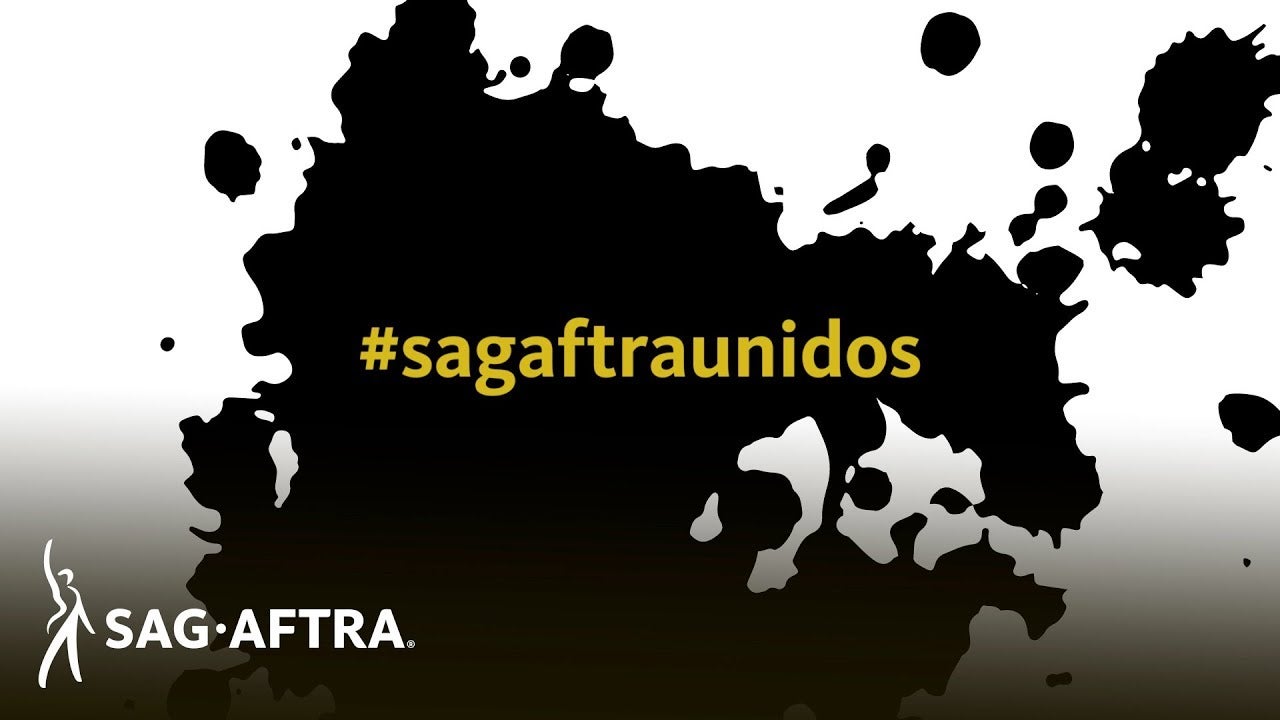 #sagaftraunidos in yellow on black splatter background 