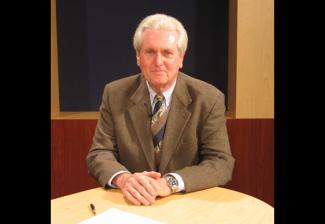 A photo of Washington-Mid Atlantic member John R. Harter seated at a desk.