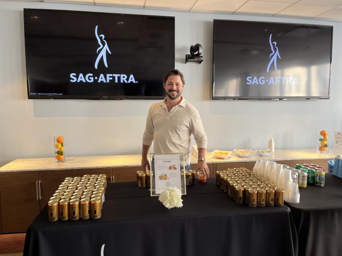 New York NextGen Performers Committee member Billy Peck serves Curious Elixirs to members during a NextGen Performer event. 
