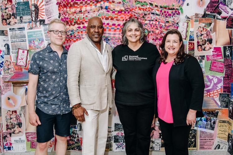 From left, Rapp, Knight, Rodriguez and Damon stand closely together. Behind them is a wall featuring colorful collage art.