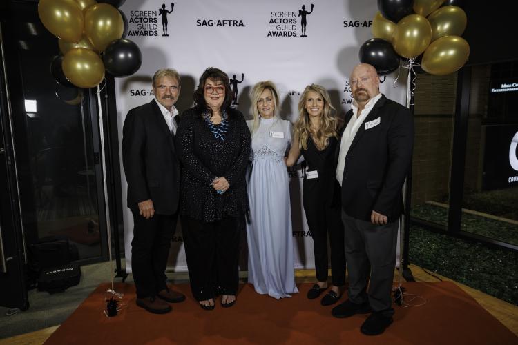 From left, Geoff, Contreras, Jan, Smalley and Rogers stand closely together on the red carpet. Behind them is a white SAG-AFTRA and SAG Awards step-and-repeat framed on either side with black and gold balloons.