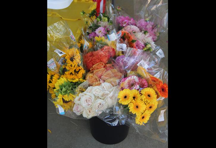 A bouquet of yellow, orange, red and white flowers.