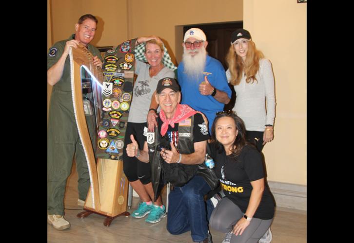 The group poses indoors with Baker's harp.