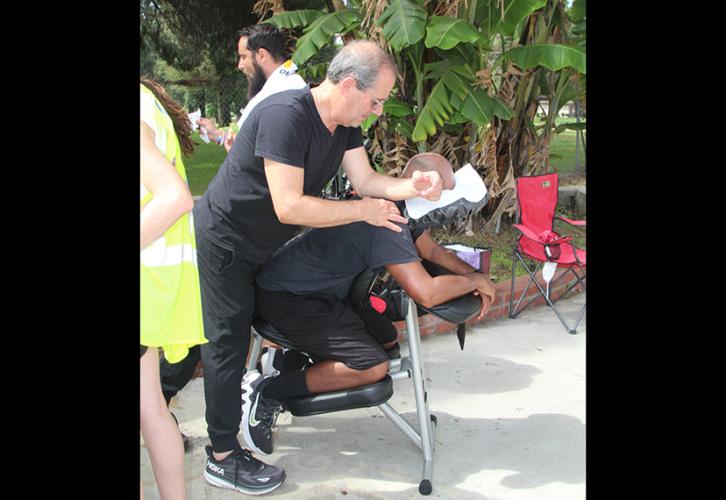 A masseuse gives a quick massage to a picketer at the Fox Studios picket line. 