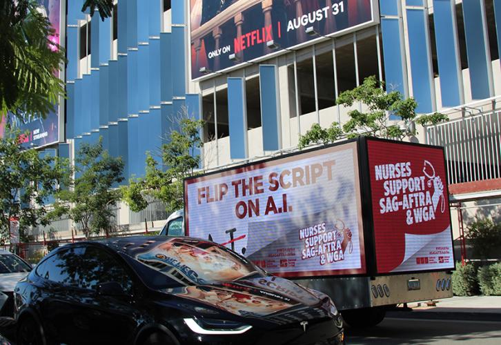A truck is parked on the street. On the back it says "Nurses Support SAG-AFTRA & WGA"