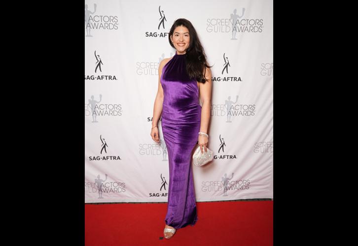 A woman in a purple dress on the red carpet