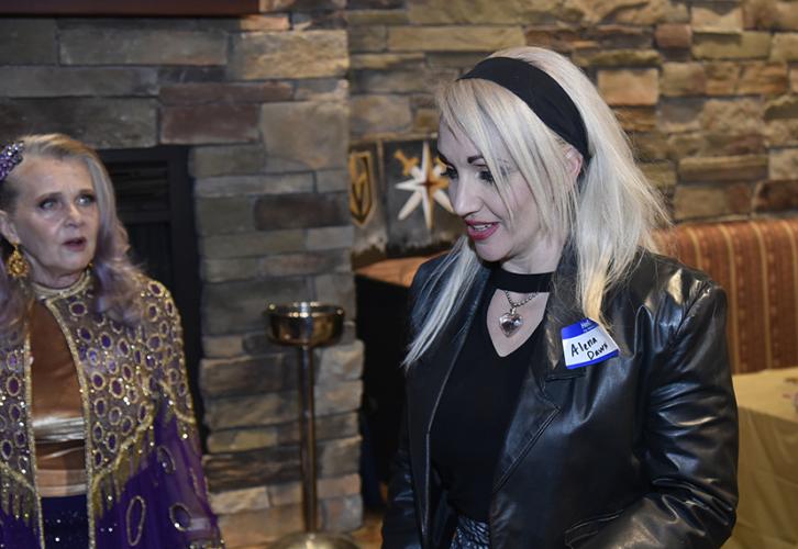 Dawn wears a leather jacket and Renee looks on in the background.