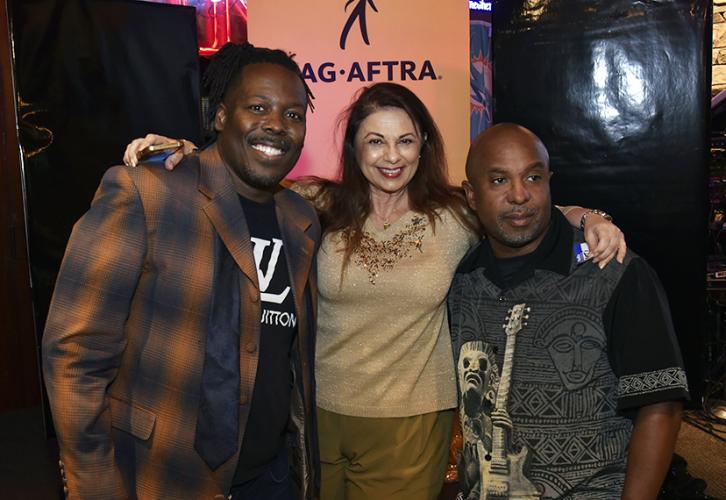 Members pose in front of a SAG-AFTRA banner