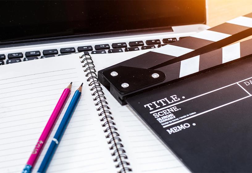 Image of notebook and clapperboard.