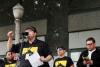 DJ Mr. Boro #SOSSBS DJ Mr. Boro standing at microphone speaking to crowd with SBS employees behind him