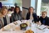 SAG-AFTRA members Michelle Franzen, Dara Aaron Kennedy, Monica Guy and Anita Bonita attend the Women in Broadcast Brunch on Nov. 20 at Rosa Mexicano in Lincoln Square. Four women sit at a round table in a restaurant. There are windows behind them and a bowl of guacamole at the center of the table.