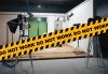 Caution tape reading "DO NOT WORK" in front of a set