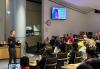 SAG-AFTRA member Ryan Walker teaches social media basics to his fellow members currently working in commercials. A group of individuals look on as another individual teaches at the front of a room.
