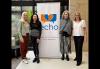 From left, SAG-AFTRA National Sexual Harassment Prevention Committee Co-Chair and L.A. Local Sexual Harassment Prevention Committee Co-Vice Chair Caitlin Dulany, Los Angeles Local President Jodi Long, SAG-AFTRA member Pamela Guest, and Echo Executive Director Louise Godbold pose at SAG-AFTRA Plaza for the Echo trauma and resilience training. Four individuals stand around a sign with the “Echo” logo on it in orange and blue with a white background.