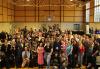 SAG-AFTRA Los Angeles strike captains attend a Friendsgiving lunch at the Hollywood United Methodist Church the Wednesday before Thanksgiving. A crowd gathers for a photo in a gym.