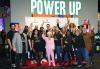 Members of the L.A. Local Host Committee pose before welcoming Los Angeles Local SAG-AFTRA members to the 2024 L.A. Local SAG Awards viewing party, held at Dave & Buster’s. A group of men and women pose with their hands raised high cheering in front of a SAG-AFTRA backdrop.