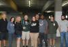 Teamsters drivers take a group photo after their morning huddle before heading to their strike sites. People stand for a group shot in a parking garage.