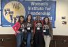 SAG-AFTRA New England Local Secretary Liz Eng, member Megan Carroll, President Andrea Lyman, and Vice President, Mid-Sized Locals Michele Proude Four women stand against a wall in front of a blue banner that reads “Women’s Institute for Leadership Development.” They each wear SAG-AFTRA Pride T-shirts.