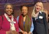 Andrea Lyman, Denise Simmons and Kristen Strezo. Lyman, dressed in maroon and wearing a scarf, holds a coffee cup. Simmons, in blue, wears a brown scarf. Strezo is dressed in a dark siut.
