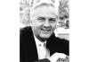 Bob Kaliban Black and white headshot of Kaliban in suite.