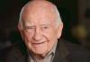 SAG-AFTRA Mourns the Passing of Former SAG President Ed Asner Asner in dark brown blazer smiling and looking off to the right