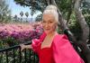 Helen Mirren to Be Honored with the 2021 SAG Life Achievement Award Helen Mirren in red dress with a green foliage background.