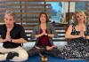 I'm Pretty Sure I've Got This video still. Performers in a yoga namaste pose with sound bowl in front of them