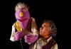 Puppeteers with purple puppet
