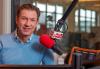 ‘Morning Edition’ Anchor Richard Hake Dead at 51 Hake in blue v-neck sweatshirt with a blue plaid collar button up underneath smiling with a WNYC microphone off to his right. Background: Studio