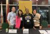 From left, New York Local board member Nick Fondulis, New England Local Board members Liz Eng and Andrea Lyman, and New England Local Executive Director Jessica Maher attended the Nov. 9 conference to speak about SAG-AFTRA’s role in the film industry. A man and three women, dressed casually, stand behind a black table. They wear lanyards around their necks and there is a yellow SAG-AFTRA banner behind them, aslong with four flags.