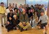 New England members after working with acting coach and SAG-AFTRA Local New England member Bates Wilder. A diverse group of people sit, stand, and kneel for a group photo after the acting class with instructor Bates Wilder.