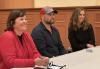SAG-AFTRA Local Executive Director Jessica Maher and Slate Casting casting directors Aaron Kahl and Ashley Skomurski answer questions at the Oct. 9 New England Conservatory event called "Stay in Sync With Slate Casting." Panelists Jessica Maher in a red top, Aaron Kahl in a baseball cap and Ashley Skomurski in black sit at a table smiling.