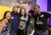 From left, SF-NC Local Business Rep Shinhong Byun, Bay Area Film Mixer co-founder Dave Moutray, SF-NC Local Board member Solana Paz, Valentina Reneff-Olson and SAG-AFTRA member John Halfacre. A diverse group of mixer attendees stand together and smile in front of a yellow banner in a room with windows and art hanging on the wall.