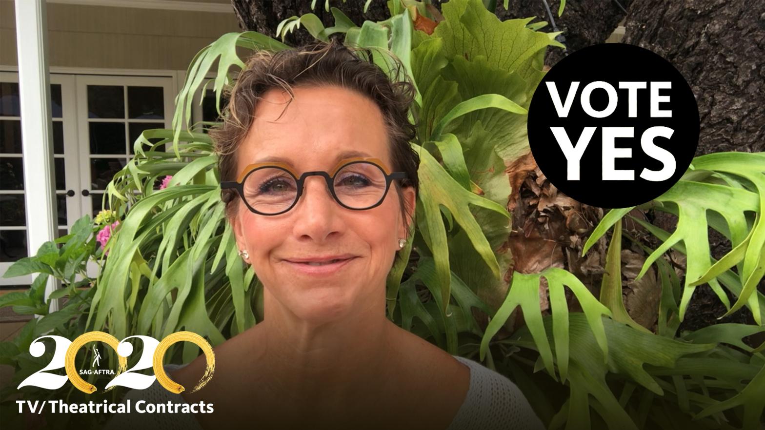 SAG-AFTRA President Gabrielle Carteris on Why She's Voting Yes Carteris in front of green foliage smiling. "VOTE YES" in white text in a black circle in the top right corner and White 2's and gold brush stroke 0's written out in 2020 with "TV?Theatrical Contracts" in white below in bottom right corner