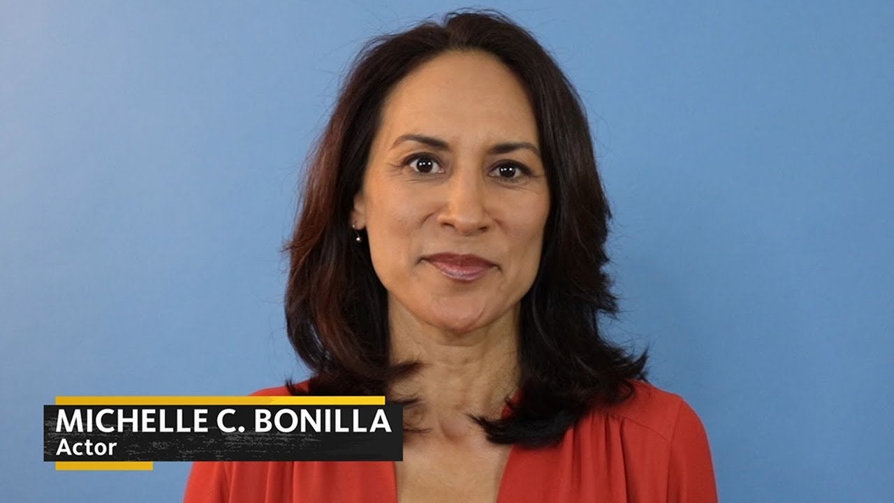 Bonilla in pink top on a blue background